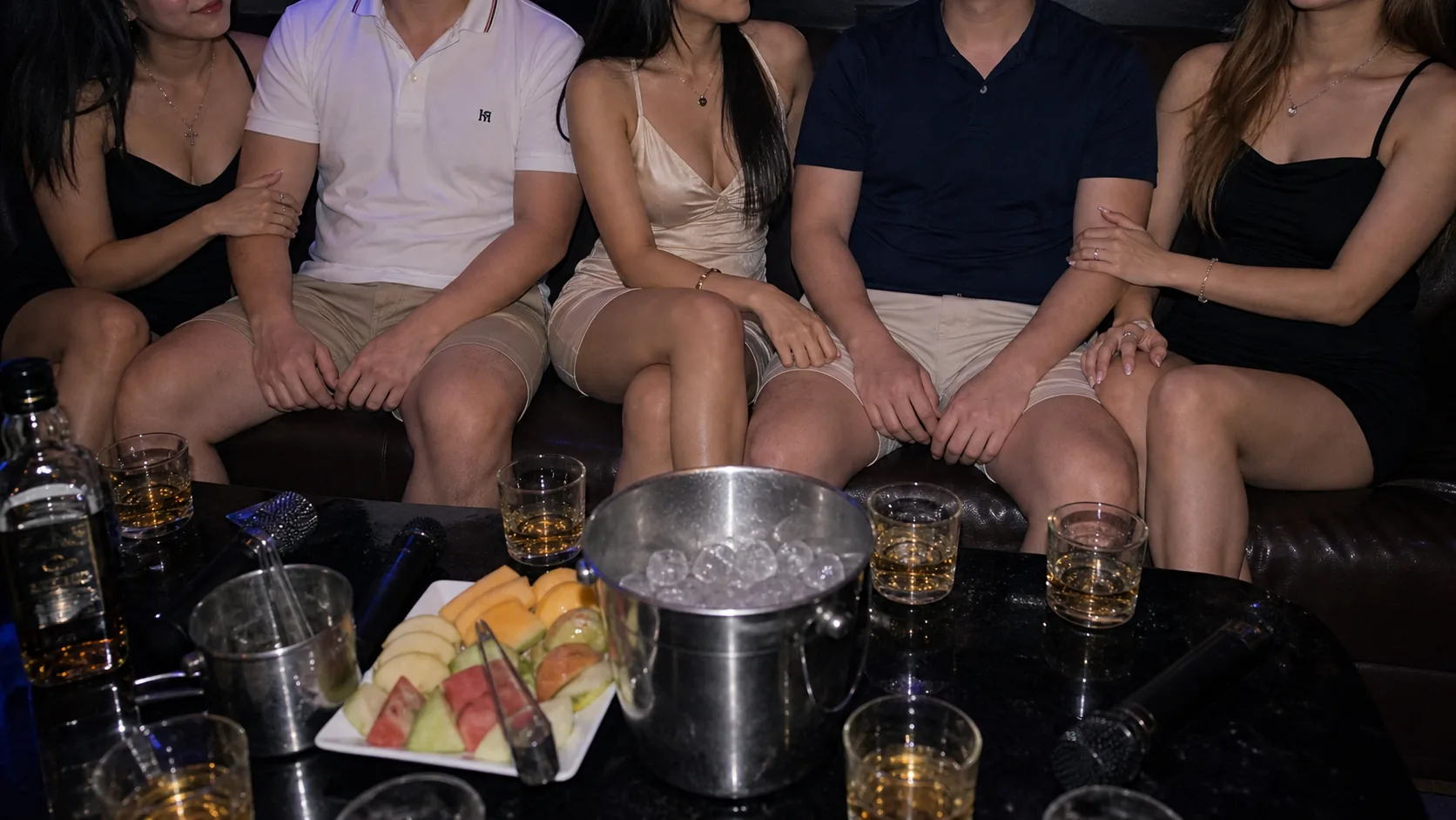 KTV group table with man-woman paired seating and drinks
